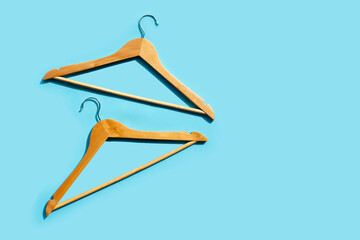 Wooden clothes hangers on blue background