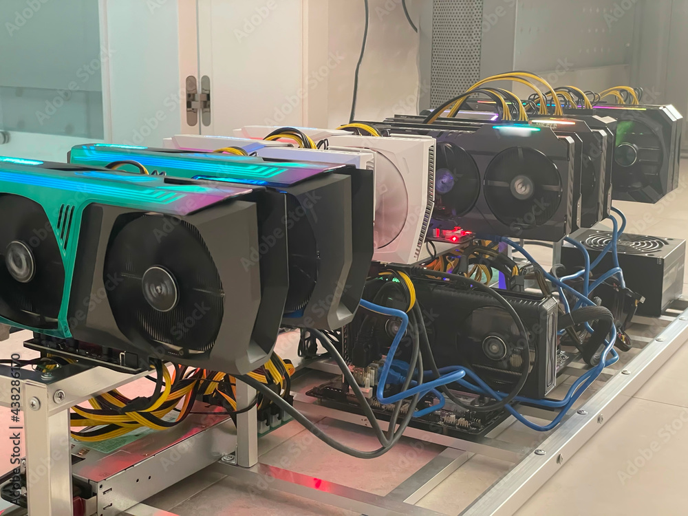 Row of bitcoin miners set up on the wired shelfs. Device for mining crypto currency. Mining cryptocurrency. Bitcoin farm. Machines for mining cryptocurrency bitcoin. Electronic device at day. - obrazy, fototapety, plakaty 