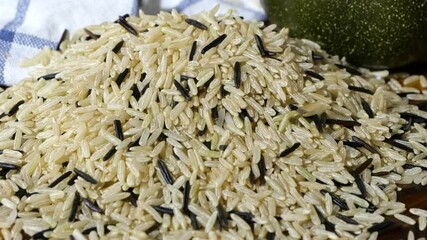 Wall Mural - Pouring a blend of Brown Jasmine and Wild Rice onto a wood cutting board 
