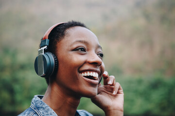 Wall Mural - Woman listening to music in nature