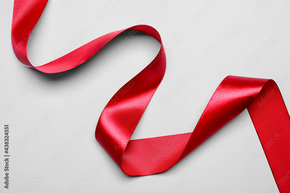 Red ribbon on light background
