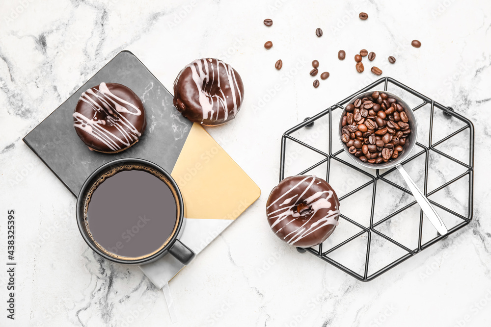 Composition with cup of coffee and donuts on marble background