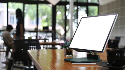 Wall Mural - Mock up computer with empty screen on wooden table at creative office.