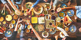 Fototapeta Uliczki - Group of diverse people are having lunch together