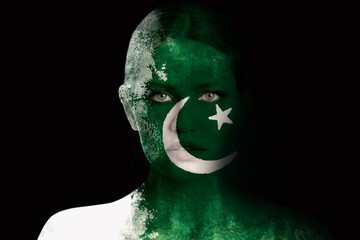 Wall Mural - Young woman with face in colors of Pakistan flag on dark background