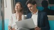 © sorapop - Young Caucasian white business woman and man sitting using laptop computer working talking together on the subway train in the morning during going to work, people transportation concept