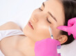 © Dimid - Cosmetologist makes rejuvenating anti wrinkle injections on the face of a beautiful woman. Female aesthetic cosmetology in a beauty salon.