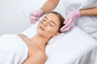 © Dimid - The cosmetologist makes the procedure Microdermabrasion of the face skin of a beautiful girl in a beauty salon.Cosmetology and professional skin care.