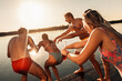 © Zoran Zeremski - Young friends having fun enjoying a summer day swimming and jumping at the lake.