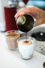 Dirty coffee glass, cold milk topped with hot espresso coffee shot.