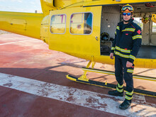Rescuer Standing By Yellow Helicopter