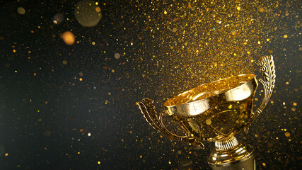 Champion golden trophy isolated on black background. Concept of success and achievement. Gold glitters explosion.