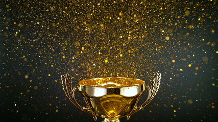 Champion golden trophy isolated on black background. Concept of success and achievement. Gold glitters explosion.