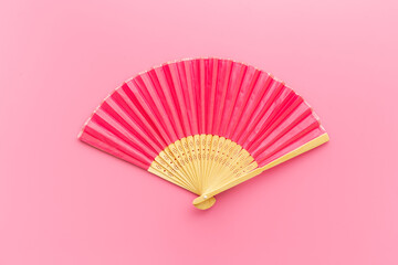 Wall Mural - Pink open hand fan made of bamboo and paper. Top view