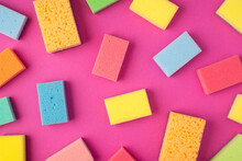 Top View Photo Of Multicolor Sponges On Isolated Pink Background
