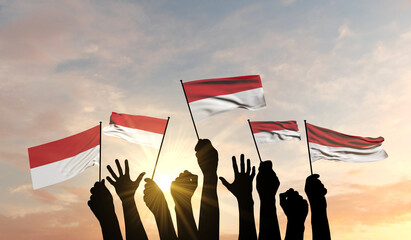 Sticker - Silhouette of arms raised waving a Indonesia flag with pride. 3D Rendering