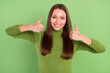 © deagreez - Photo of positive nice pretty young woman make thumbs up recommend isolated on green color background