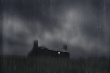 A Ruined House In The Middle Of The Countryside. With A Light Shining From A Broken Window On A Stormy Night