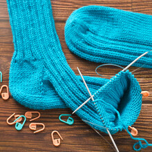 Knitting A Warm Sock From Blue Wool Yarn