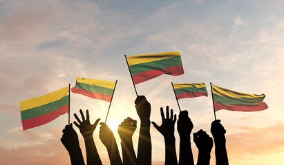 Sticker - Silhouette of arms raised waving a Lithuania flag with pride. 3D Rendering