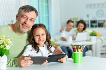 Wall Mural - Father with little daughter using  tablets