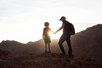 Wall Mural - Dad with son in the mountains in the desert