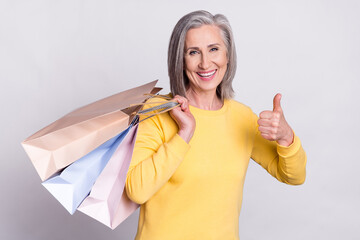 Photo of happy good mood lovely sweet grandmother show thumb-up recommend shop isolated on grey color background