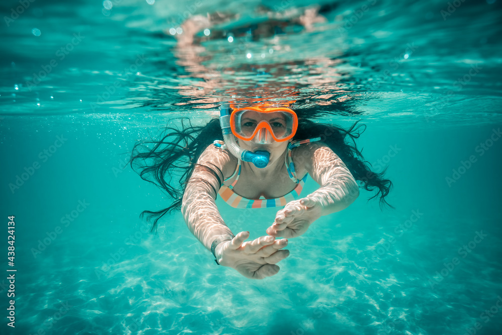 Underwater view of beautiful woman swimming in blue ocean water Stock ...