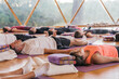 © ADDICTIVE STOCK - Calm people lying on yoga mats with eyes closed in yoga class