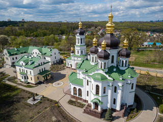 Wall Mural - Orthodox church on the outskirts of the forest. Aerial drone view.