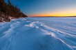 Snow drifts along frozen shoreline of Torch Lake in Northern Michigan.  