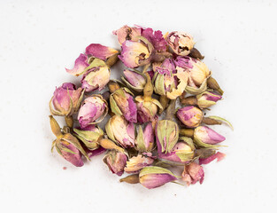 Wall Mural - pile of old dried rosebuds close up on gray