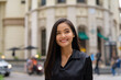 © Ranta Images - Portrait of beautiful Asian businesswoman outdoors in city street