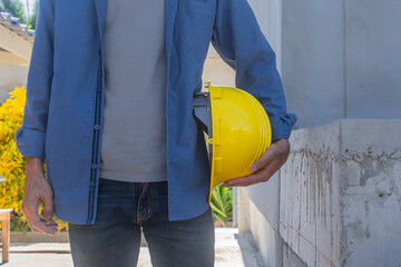 Wall Mural - Engineering Engineer Architect holding hard hat helmet working on site building construction