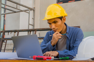 Worker employee working by computer technology on site construction