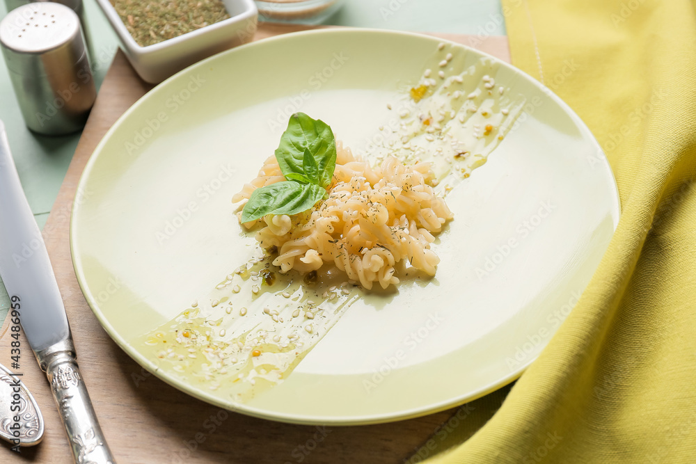 Plate with tasty pasta on table, closeup