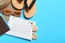 Calendar And Beach Accessories On Color Background