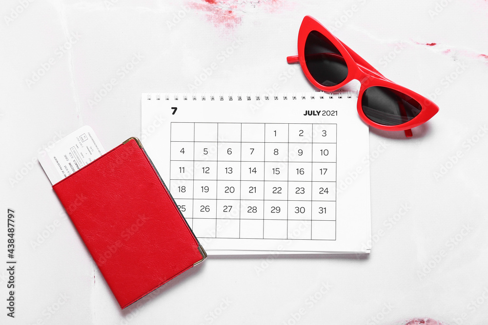 Calendar, passport, ticket and female sunglasses on light background
