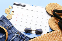 Calendar And Beach Accessories On Color Background, Closeup