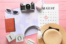 Composition With Calendar And Travel Accessories On Color Wooden Background