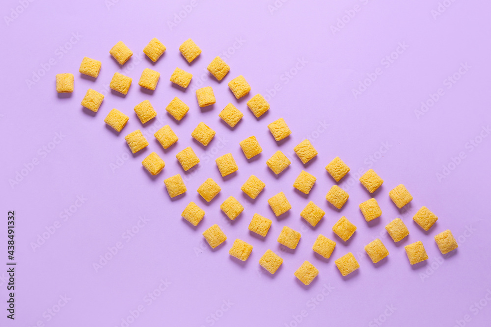 Composition with tasty corn pillows on color background