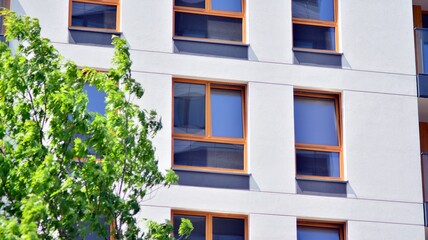 Fragment of modern luxury residential apartment,  home house building concept. Modern apartment building on a sunny day with a blue sky.