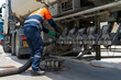 © Chatchawal - A tanker truck driver delivers gasoline to a gas station