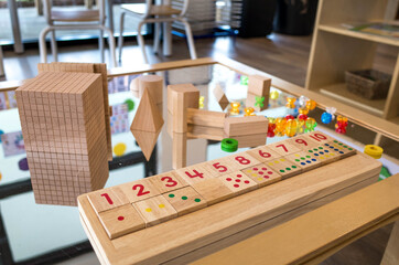 Some educational kids wooden counting toys placed on a table. Classic developmental toys for preschoolers to build kids' number sense and early math skills. Concept of early education.