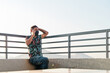 © daniel - young latino man working and talking on the phone on the roof of the building