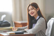 © EduLife Photos - Stock photo of a young teenage woman Asian college student in student uniform studying and writing on digital tablet in a university classroom