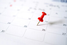 Closeup Red Pin On The Calendar. Calendar With Red Pins On The 20th, Mark The Date Of The Event With A Pin.