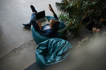 Wall Mural - Stylish young man with credit card using laptop