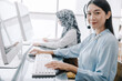 © topkritsada - secretary operator wears a headset and microphone for consultant assistance support, the call center staff providing advice and assistance customers in smiling and happy manner while looking at camera