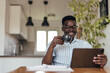 © bnenin - Adult black man, enjoying his drink, at work.